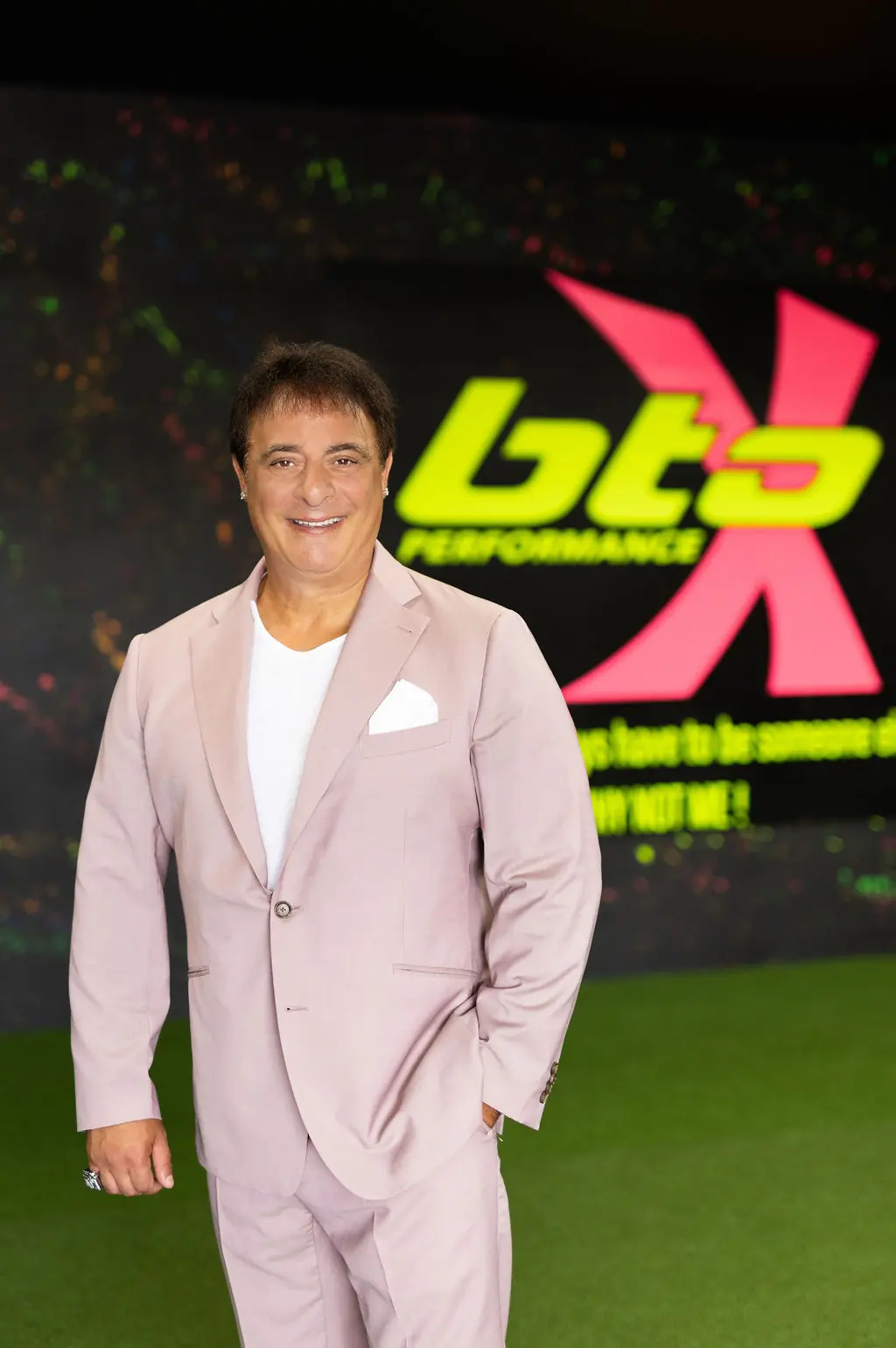 Dan Giancola at BTO Performance, the Niagara fitness studio he has run since 2012, in front of the studio's logo wall
