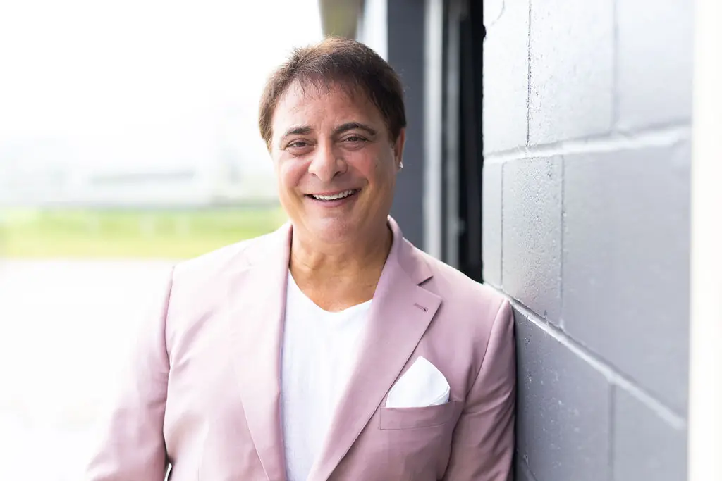 Dan Giancola, candidate for Niagara Falls City Council, smiling in a blush pink blazer